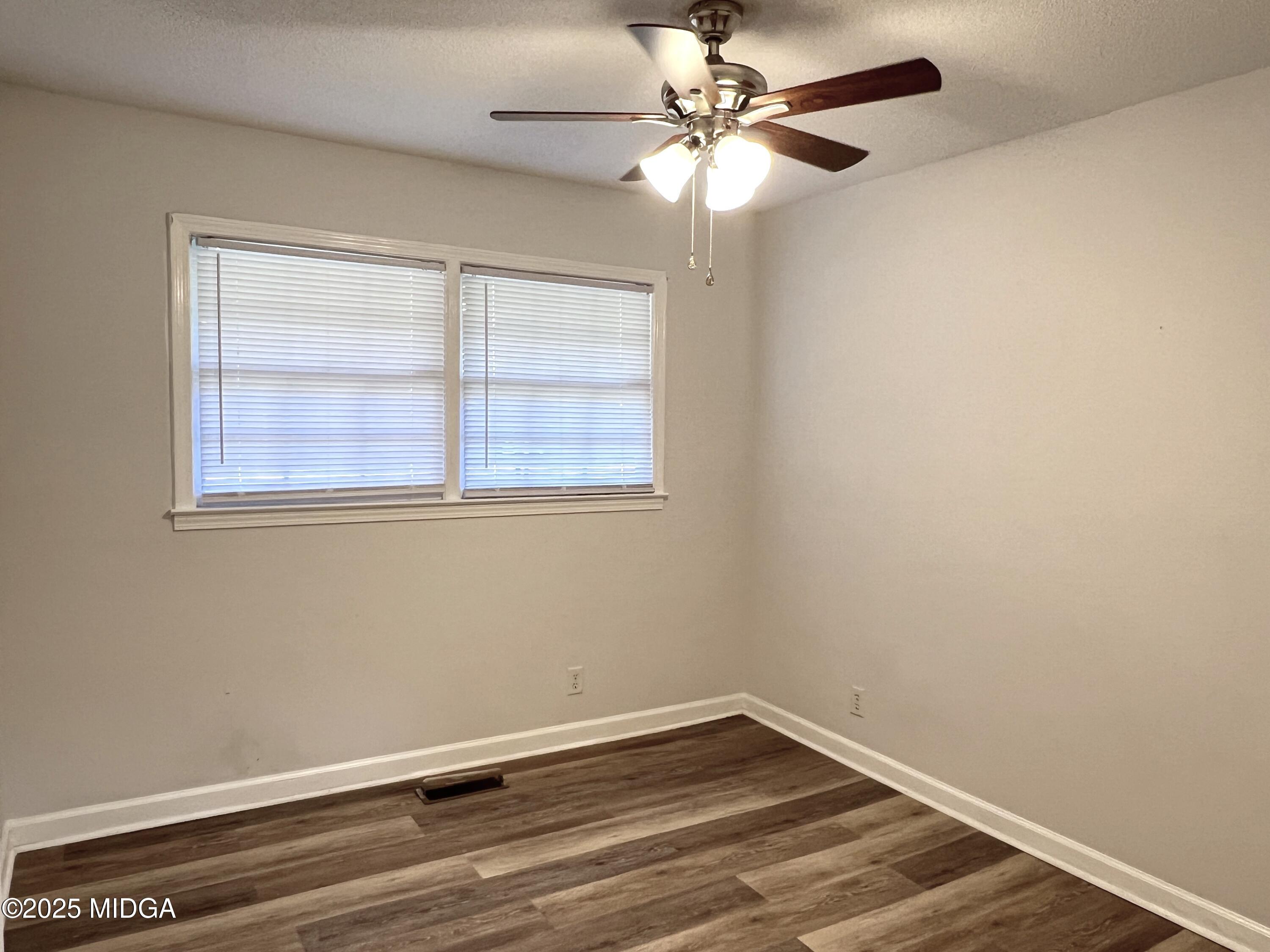 1149 Runnymede Lane Macon, GA 31220 - Photo 10 of 25 an empty room with a window and a fan