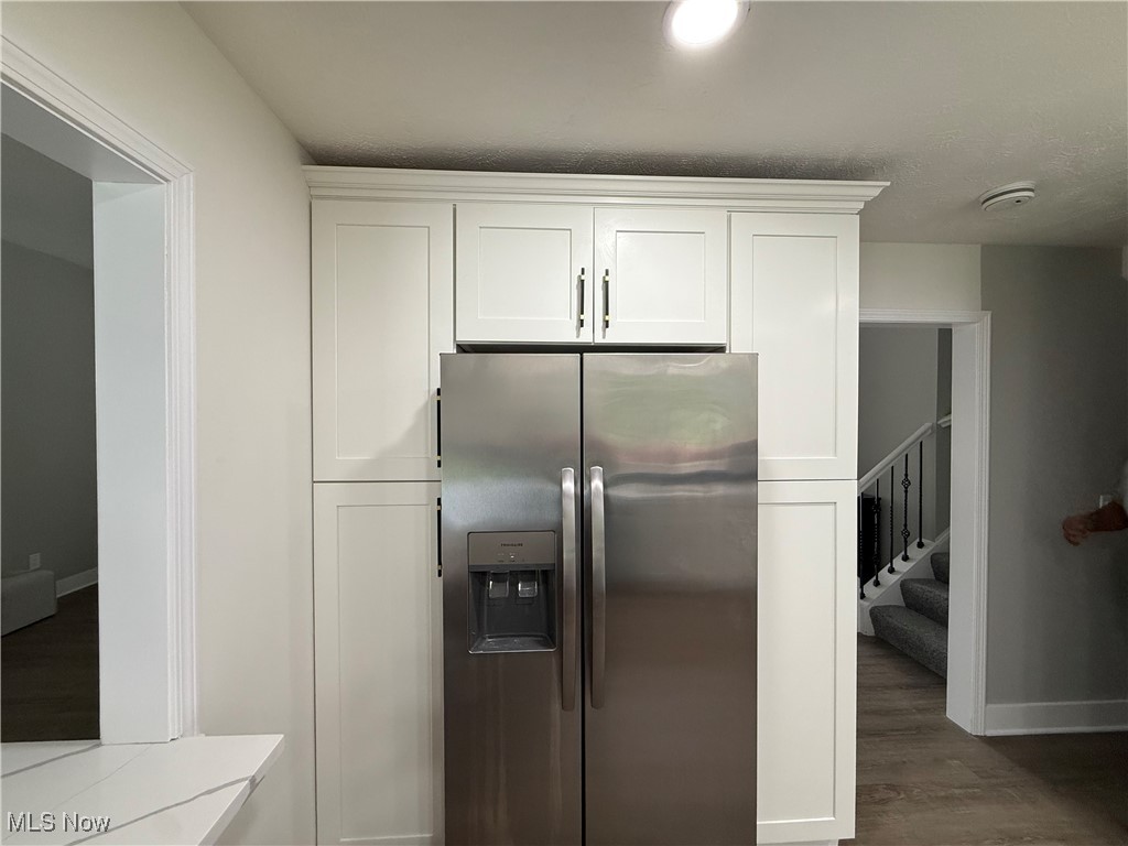 16667 Drake Road Strongsville, OH 44136 - Photo 8 of 30 Kitchen featuring stainless steel fridge, white cabinetry, and wood finished floors