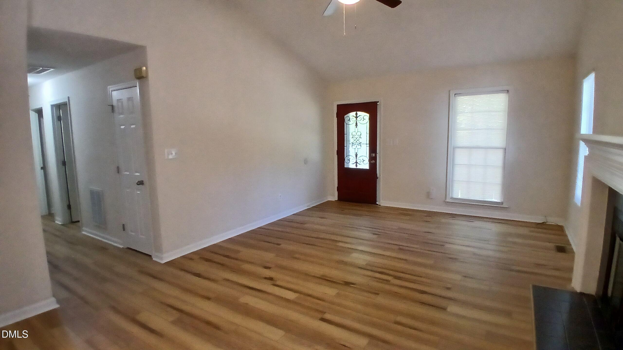 2224 Bufflehead Road Raleigh, NC 27616 - Photo 3 of 33 a view of an empty room with window and wooden floor