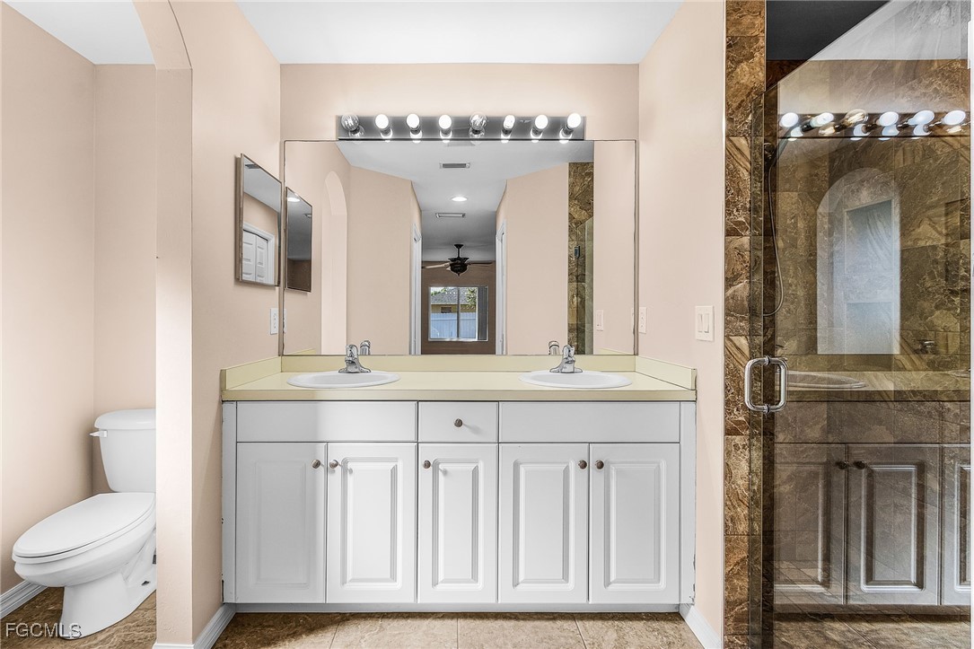 1644 Dawnview Street North Port, FL 34288 - Photo 11 of 32 a bathroom with a double vanity sink and a mirror