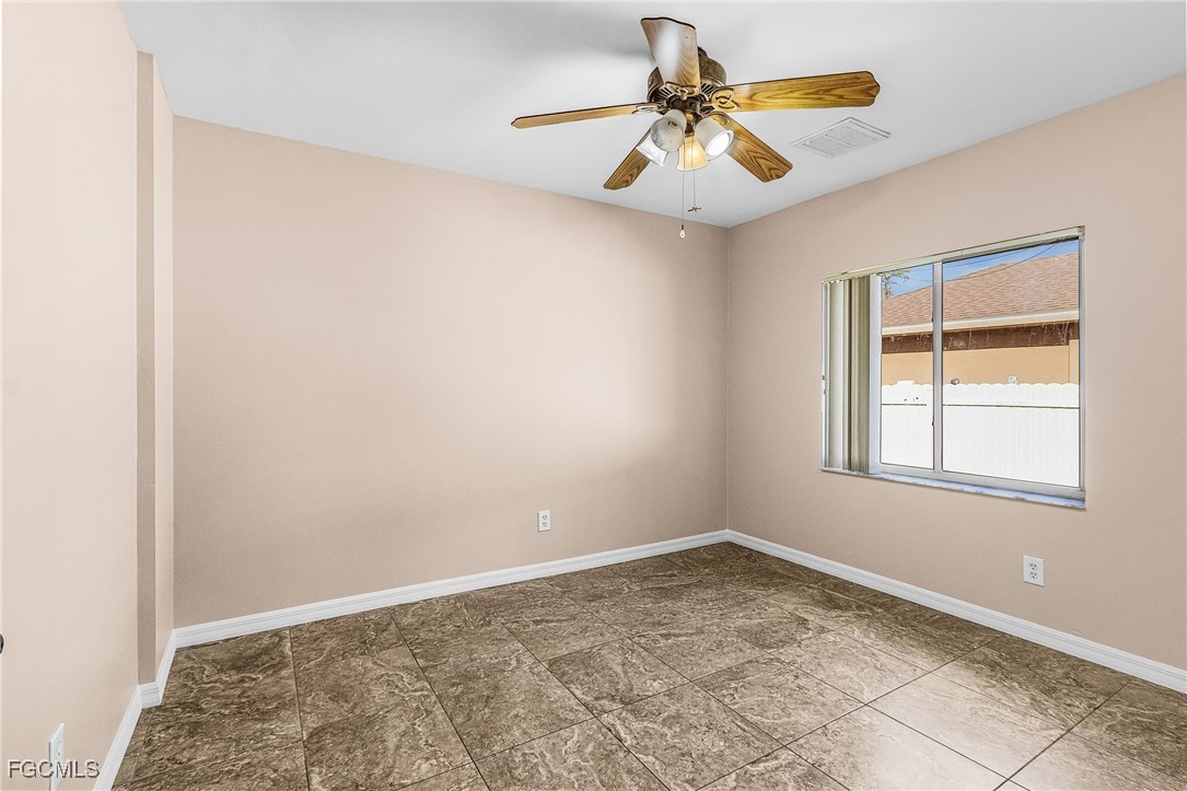 1644 Dawnview Street North Port, FL 34288 - Photo 14 of 32 an empty room with a window and a fan