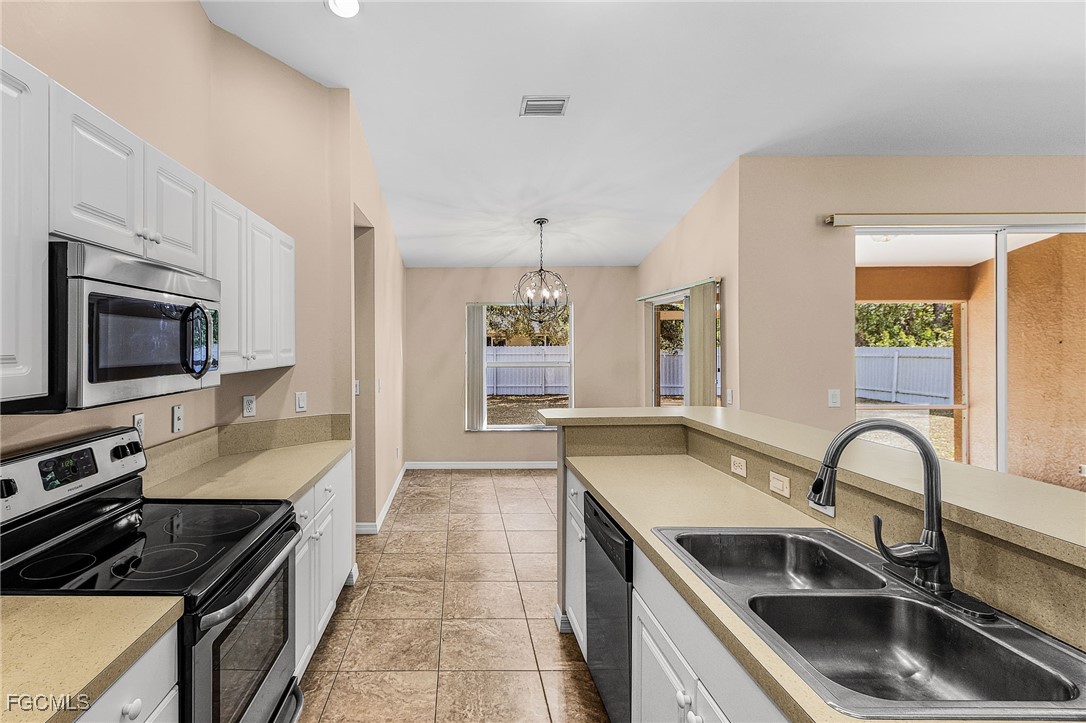 1644 Dawnview Street North Port, FL 34288 - Photo 3 of 32 a kitchen that has a sink and a stove