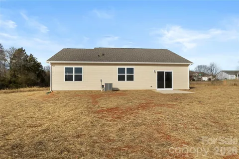 a backyard of a house with wooden fence