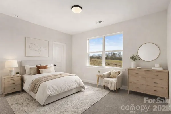 a bedroom with a bed and window