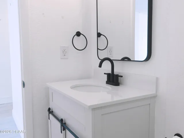 a view of a hallway with a chandelier fan