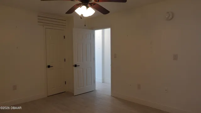 a view of a room with a fan and a window