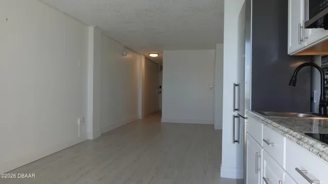 a kitchen with appliances a microwave and cabinets