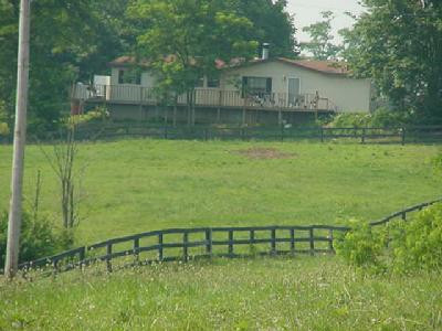 Manager's home , nestled in trees, is do