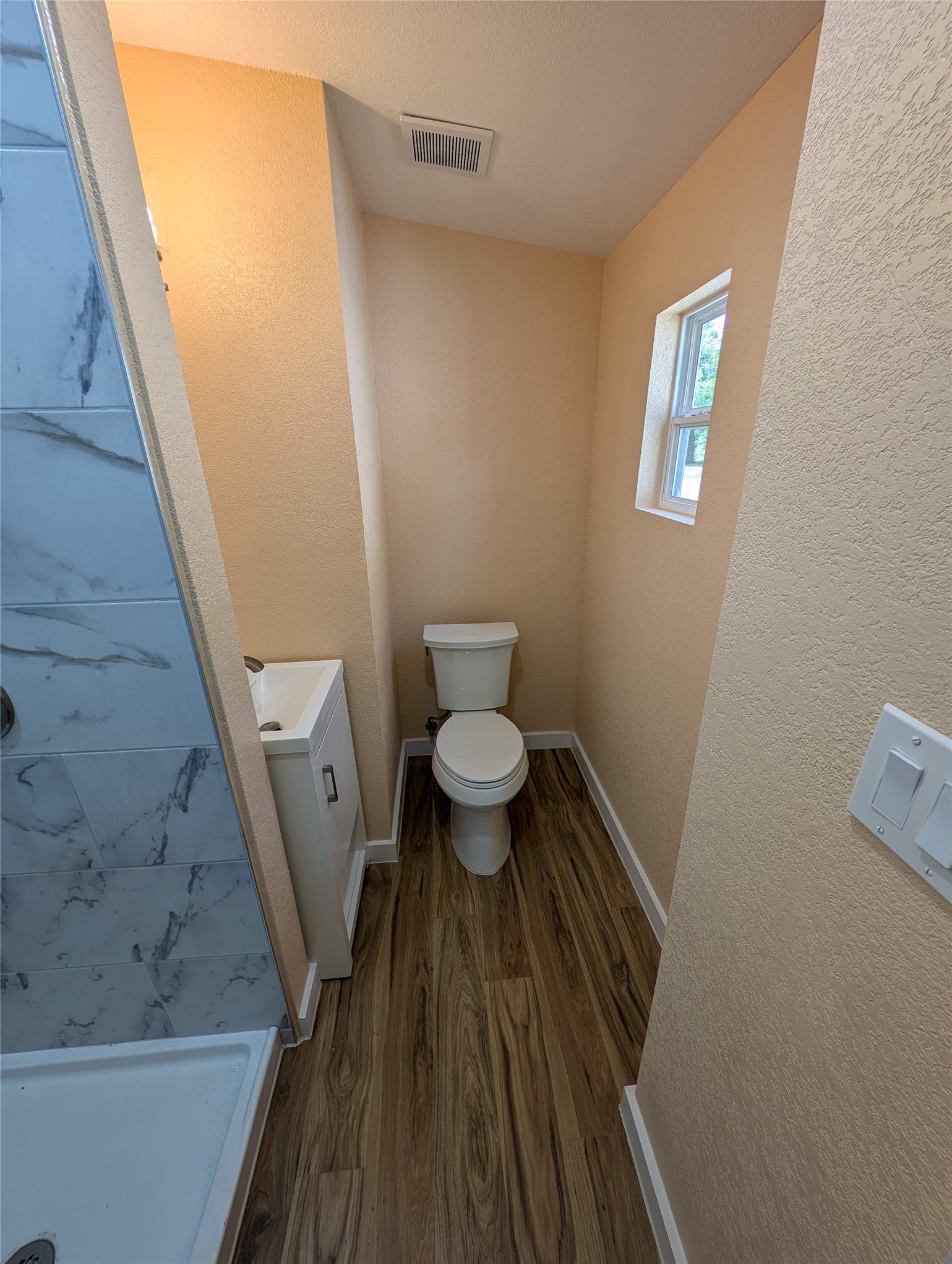 320 Laredo Street Lockhart, TX 78644 - Photo 11 of 27 a bathroom with a toilet and a sink