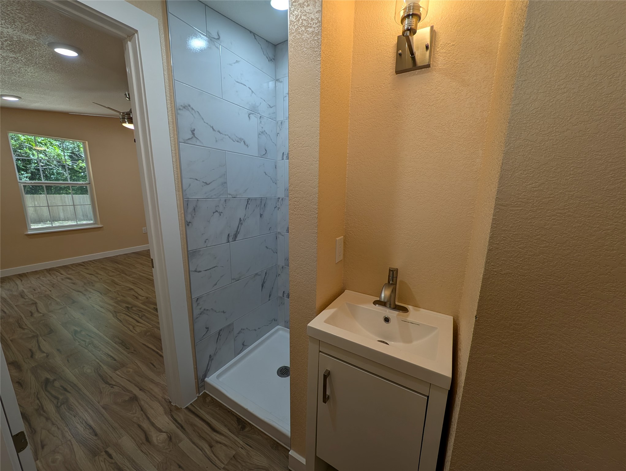 320 Laredo Street Lockhart, TX 78644 - Photo 12 of 27 a bathroom with a sink a toilet and shower