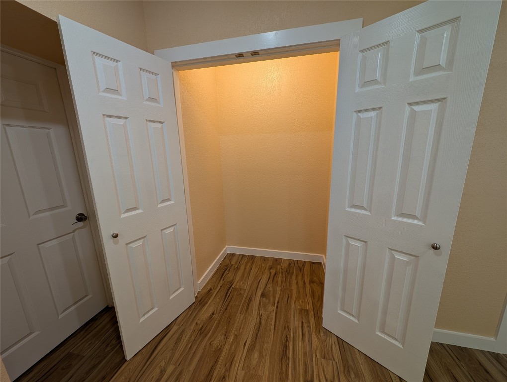 320 Laredo Street Lockhart, TX 78644 - Photo 14 of 27 Hall with dark wood finished floors