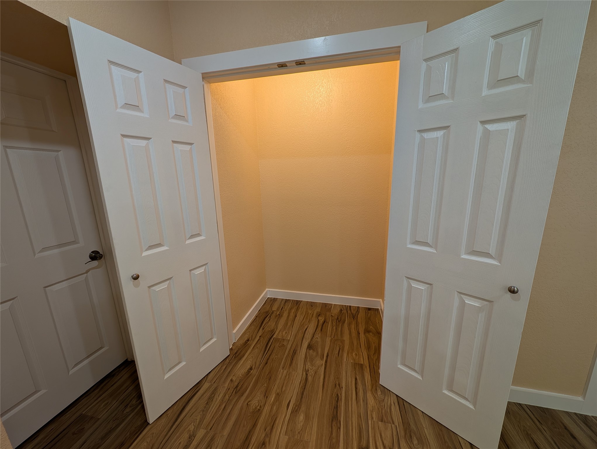 320 Laredo Street Lockhart, TX 78644 - Photo 14 of 27 a view of a hallway with wooden floor and closet