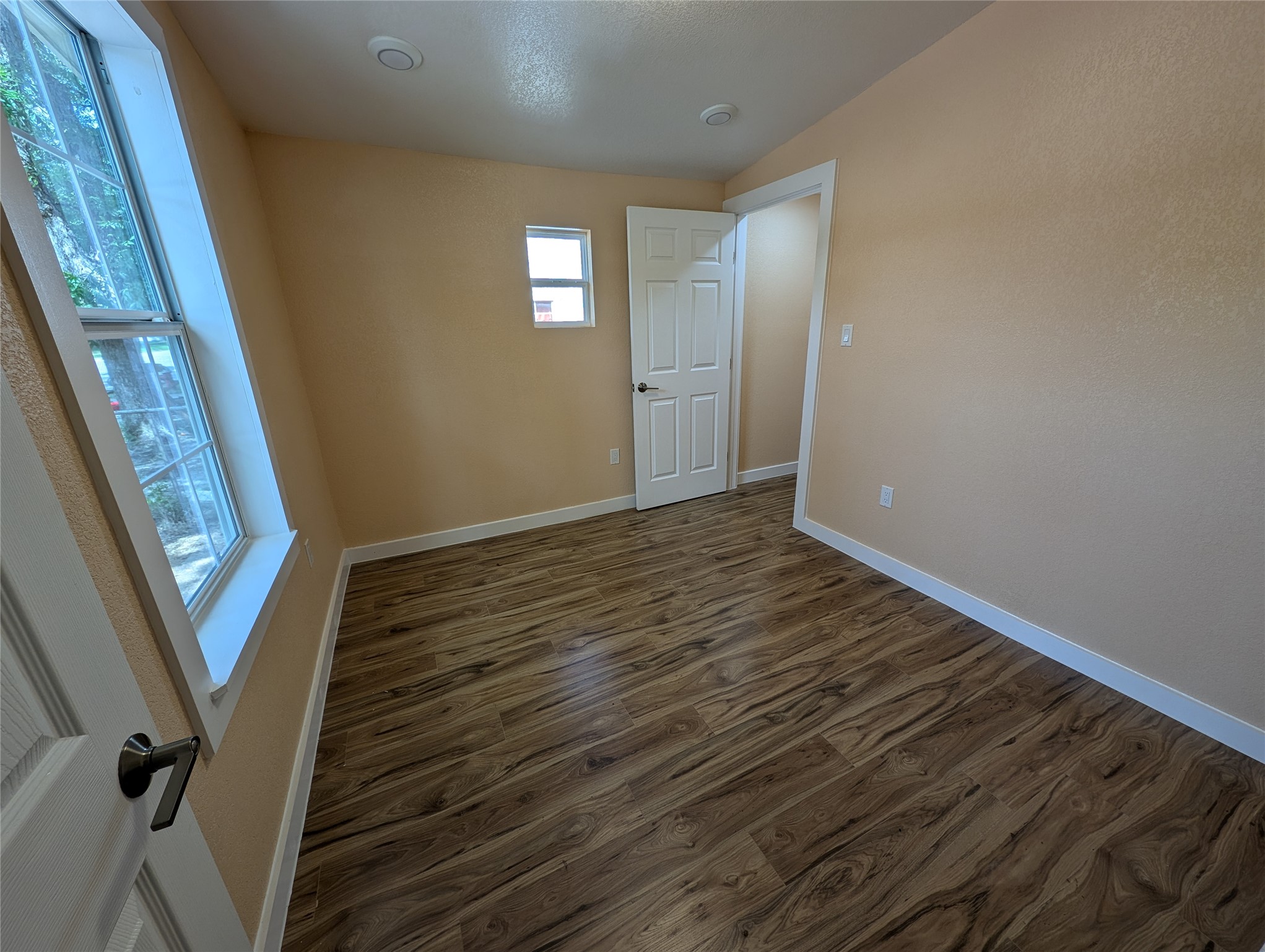 320 Laredo Street Lockhart, TX 78644 - Photo 15 of 27 a view of an empty room with wooden floor and stairs