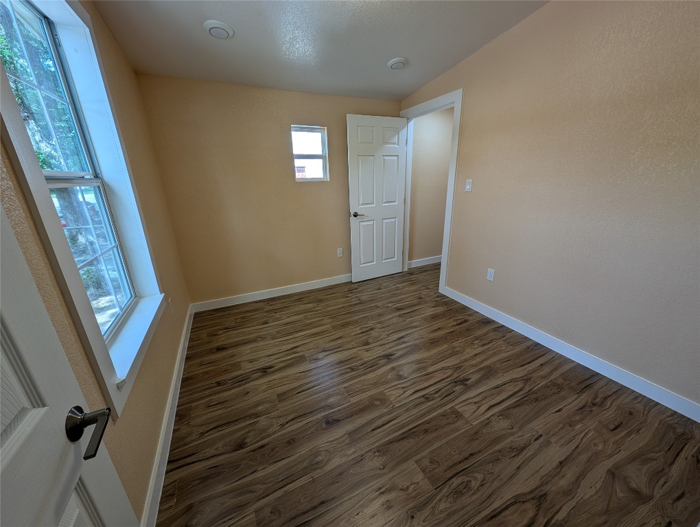 320 Laredo Street Lockhart, TX 78644 - Photo 15 of 27 Spare room featuring dark wood-style flooring