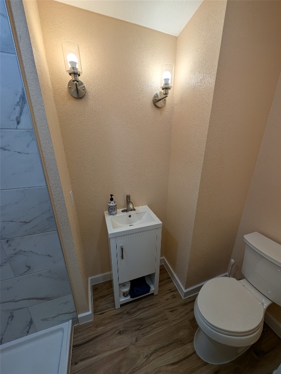 320 Laredo Street Lockhart, TX 78644 - Photo 20 of 27 Bathroom with wood finished floors, vanity, and a shower