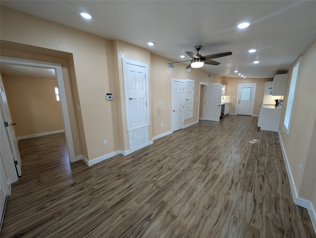320 Laredo Street Lockhart, TX 78644 - Photo 2 of 27 Unfurnished living room featuring dark wood-style flooring, recessed lighting, and a ceiling fan