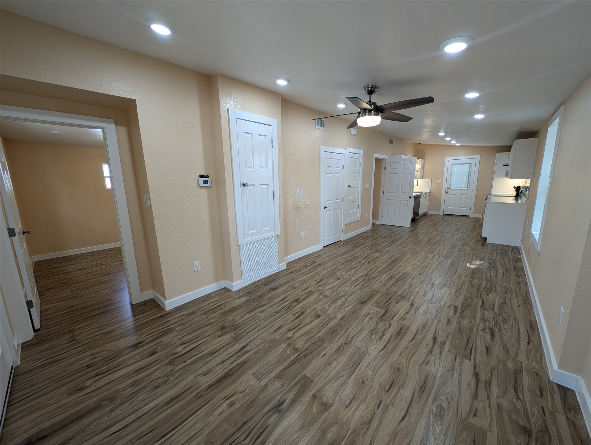 320 Laredo Street Lockhart, TX 78644 - Photo 2 of 27 wooden floor in an empty room with a window