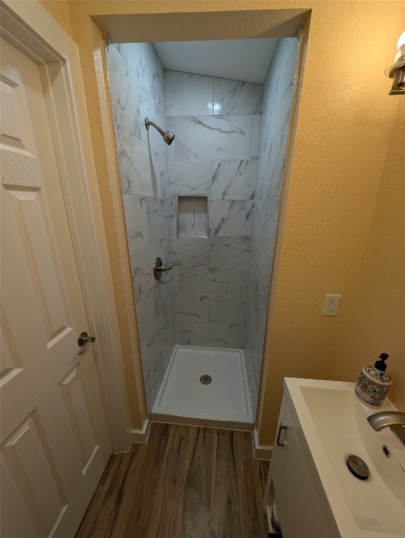 320 Laredo Street Lockhart, TX 78644 - Photo 21 of 27 Bathroom with vanity, light wood-type flooring, and a stall shower