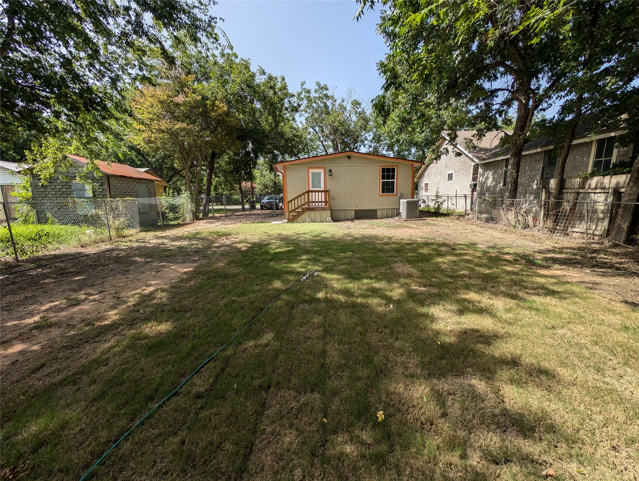 320 Laredo Street Lockhart, TX 78644 - Photo 23 of 27 a front view of a house with a yard and trees