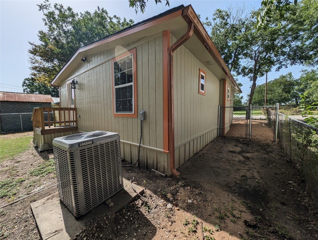 320 Laredo Street Lockhart, TX 78644 - Photo 24 of 27 View of property exterior with a gate and a central air condition unit