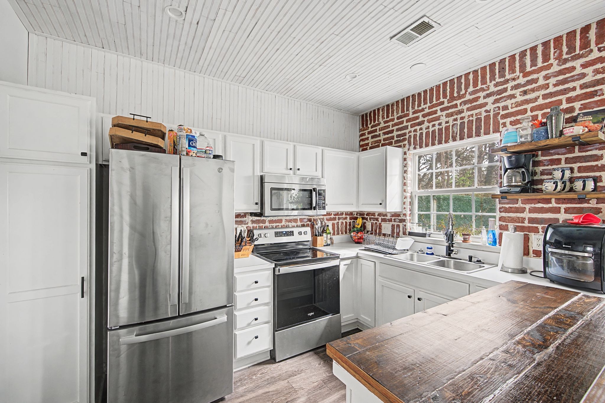 3401 Anderson Road, Unit 4 Antioch, TN 37013 - Photo 22 of 55 a kitchen with stainless steel appliances granite countertop a refrigerator a sink dishwasher a stove with white cabinets and wooden floor