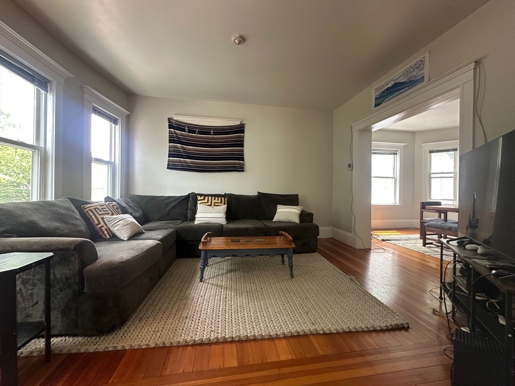 62 Bromfield Road, Unit 2 Somerville, MA 02144 - Photo 2 of 14 a living room with furniture and wooden floor
