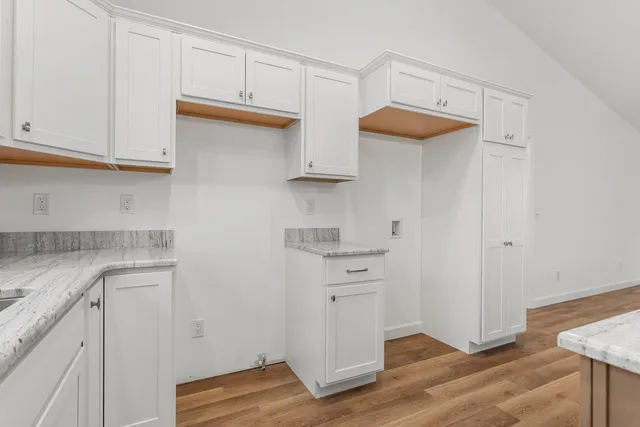 a open kitchen with kitchen island a sink a center island stainless steel appliances and a window