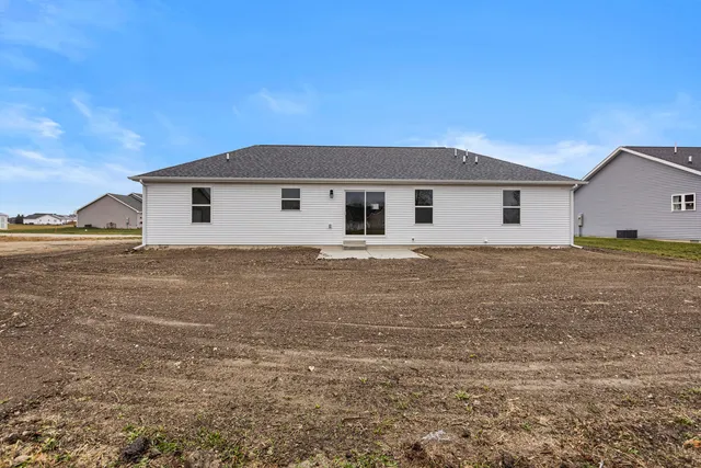 a view of a house with a backyard