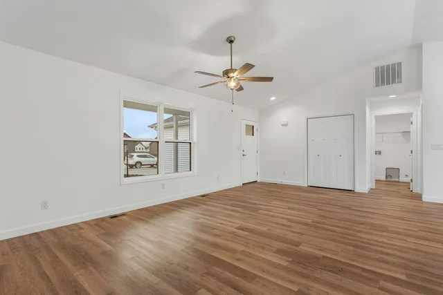 a view of kitchen with granite countertop stainless steel appliances sink and cabinets
