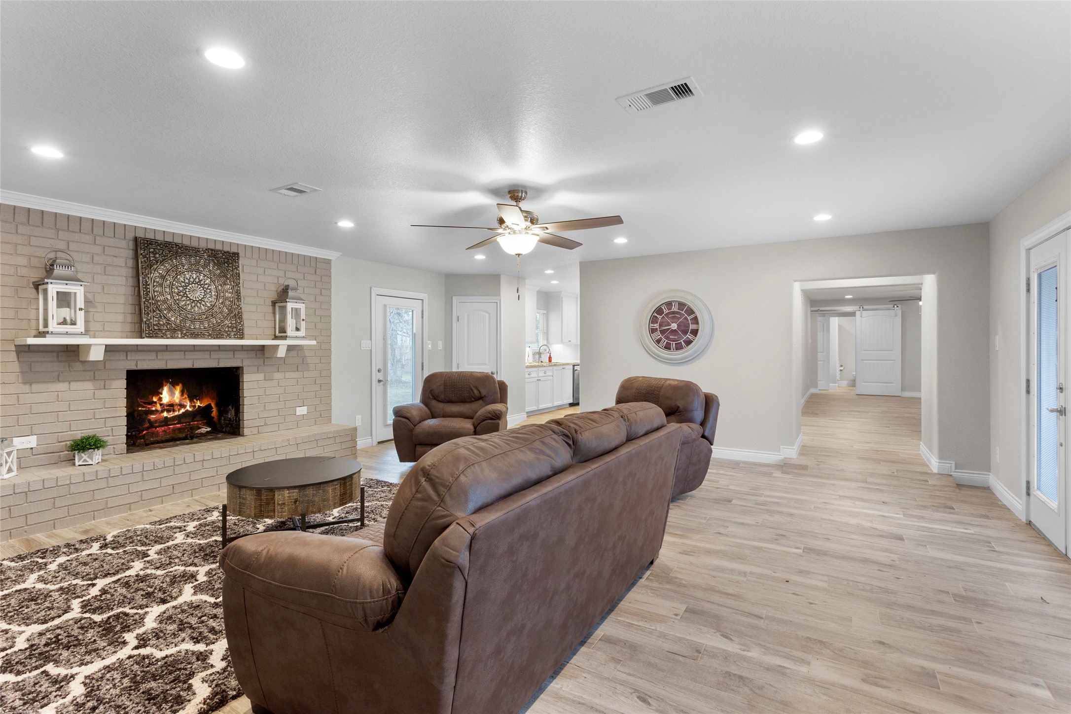 13800 West 6th Street Santa Fe, TX 77517 - Photo 2 of 35 Living room with fireplace. Wood look tile throughout the house.