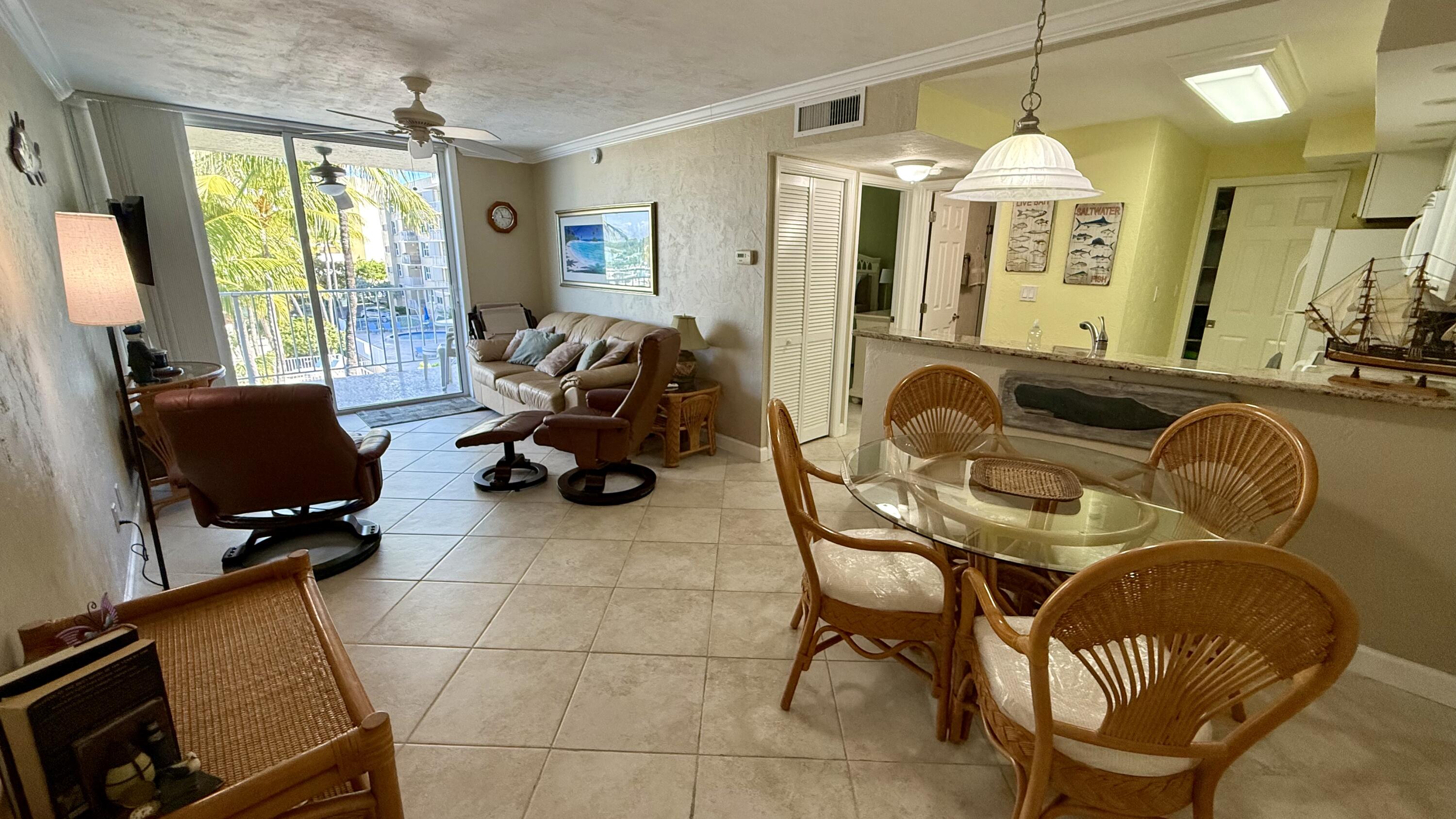 88500 Overseas Highway, Unit 320 Islamorada, FL 33036 - Photo 4 of 30 a livingroom with workspace and a couch