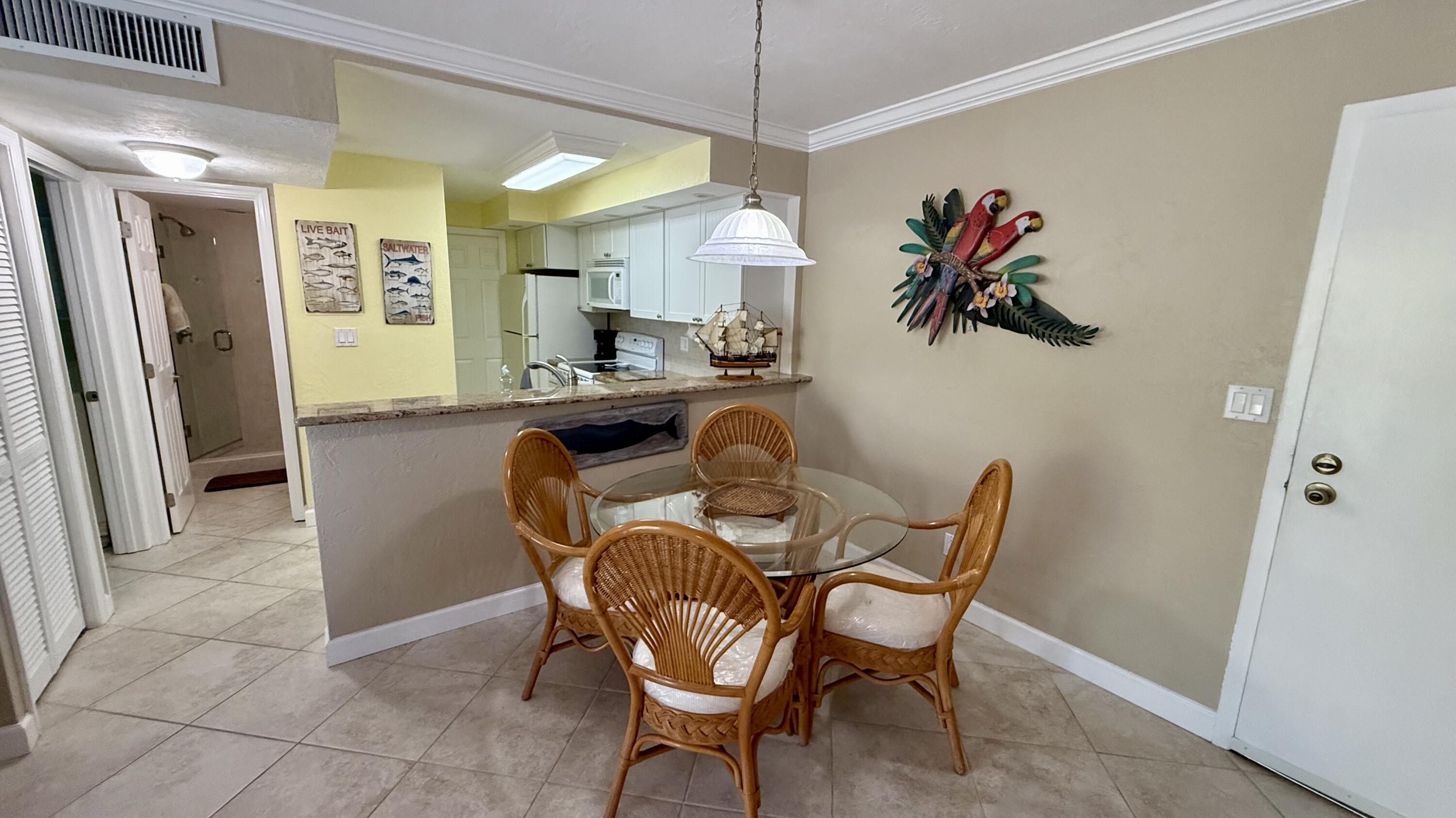 88500 Overseas Highway, Unit 320 Islamorada, FL 33036 - Photo 6 of 30 a dining room with furniture and window