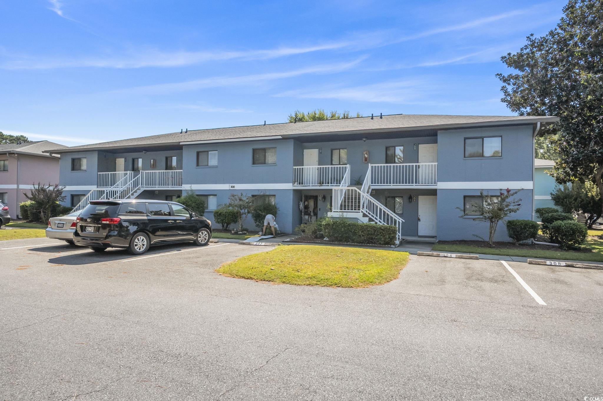 1301 Pridgen Road, Unit 304 Myrtle Beach, SC 29577 - Photo 1 of 26 View of property with stairs and uncovered parking