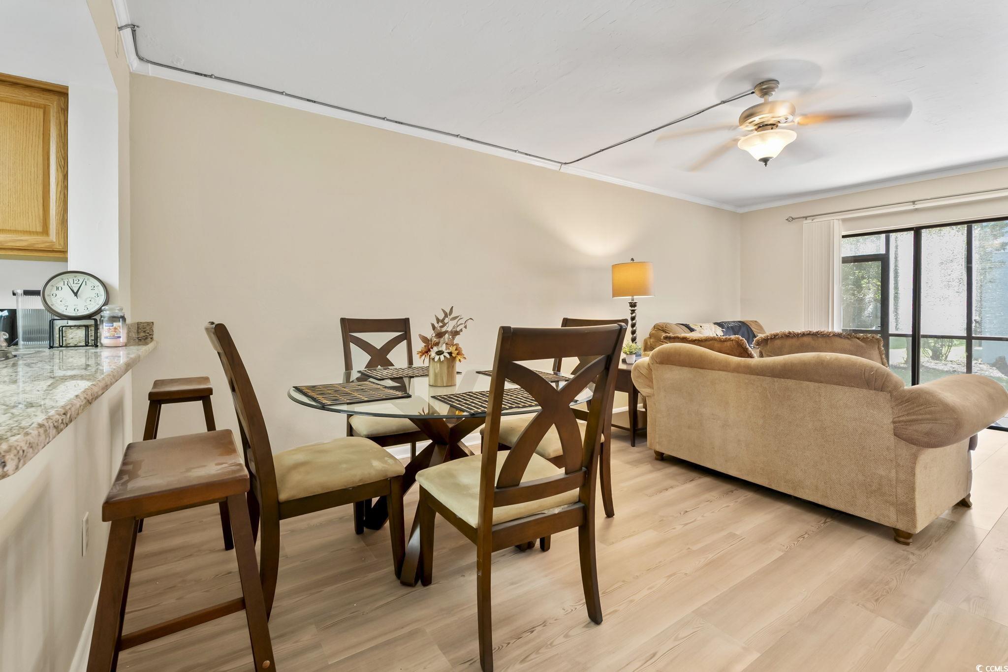 1301 Pridgen Road, Unit 304 Myrtle Beach, SC 29577 - Photo 11 of 26 Dining area with light wood-type flooring and crown molding