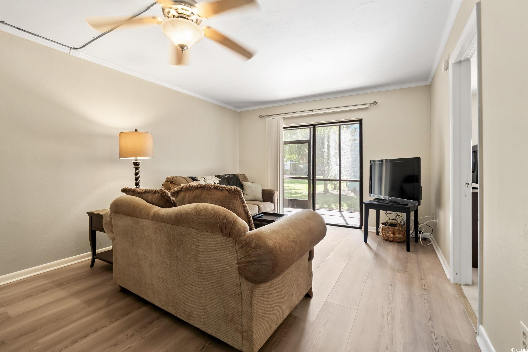 1301 Pridgen Road, Unit 304 Myrtle Beach, SC 29577 - Photo 12 of 26 Dining area featuring light wood-type flooring, crown molding, and a ceiling fan