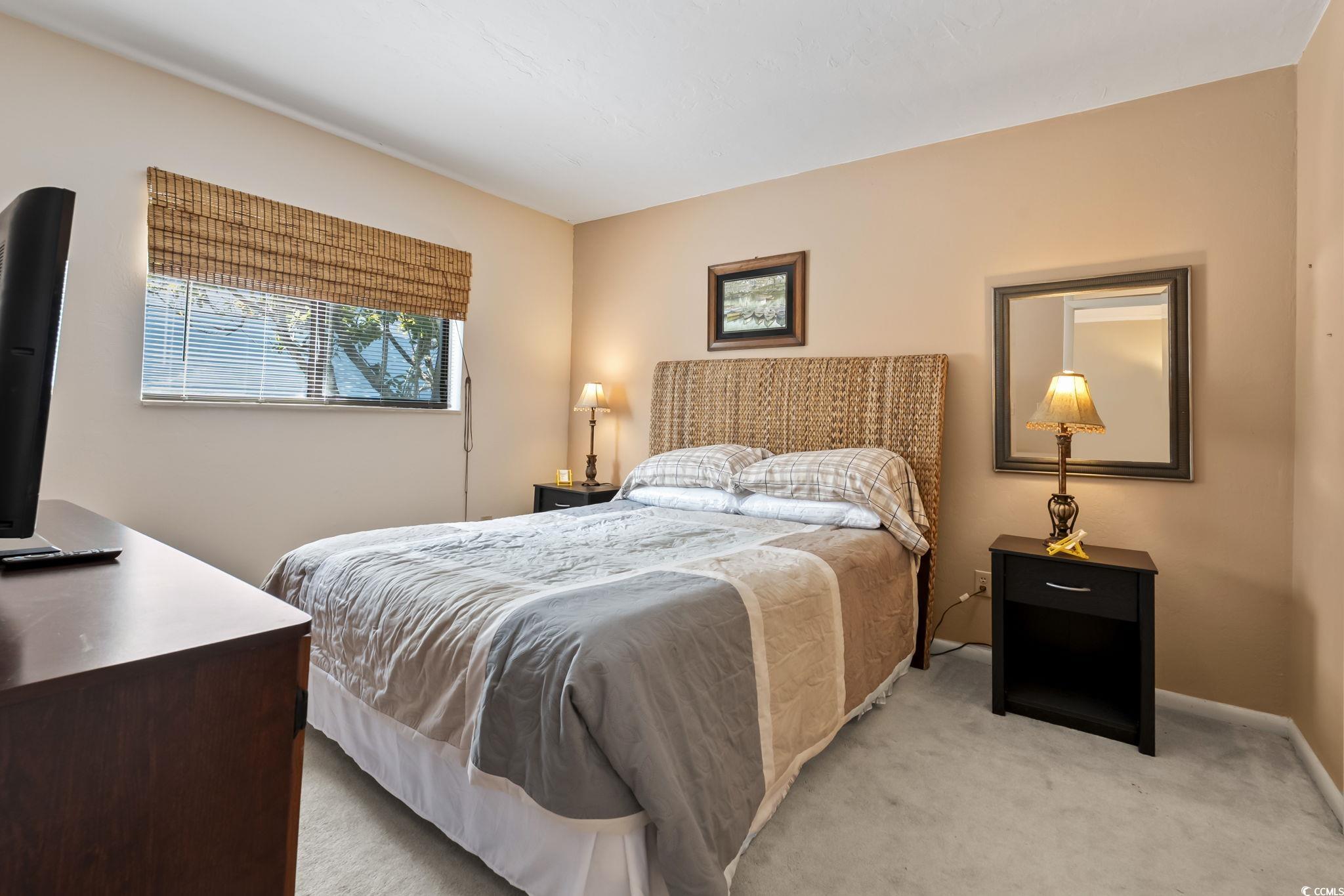 1301 Pridgen Road, Unit 304 Myrtle Beach, SC 29577 - Photo 13 of 26 Living area featuring crown molding, light wood finished floors, and a ceiling fan