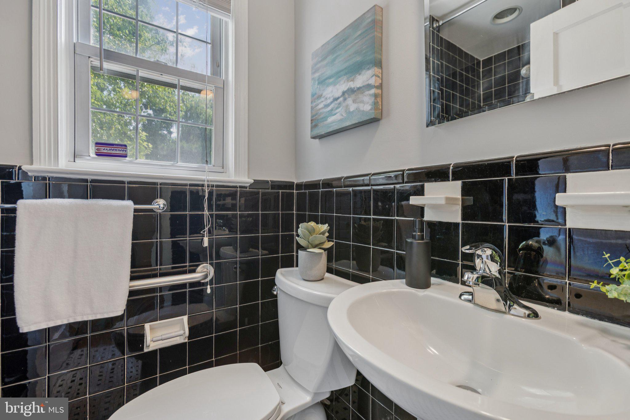 1718 Dublin Drive Silver Spring, MD 20902 - Photo 11 of 25 a bathroom with a sink a toilet and shower