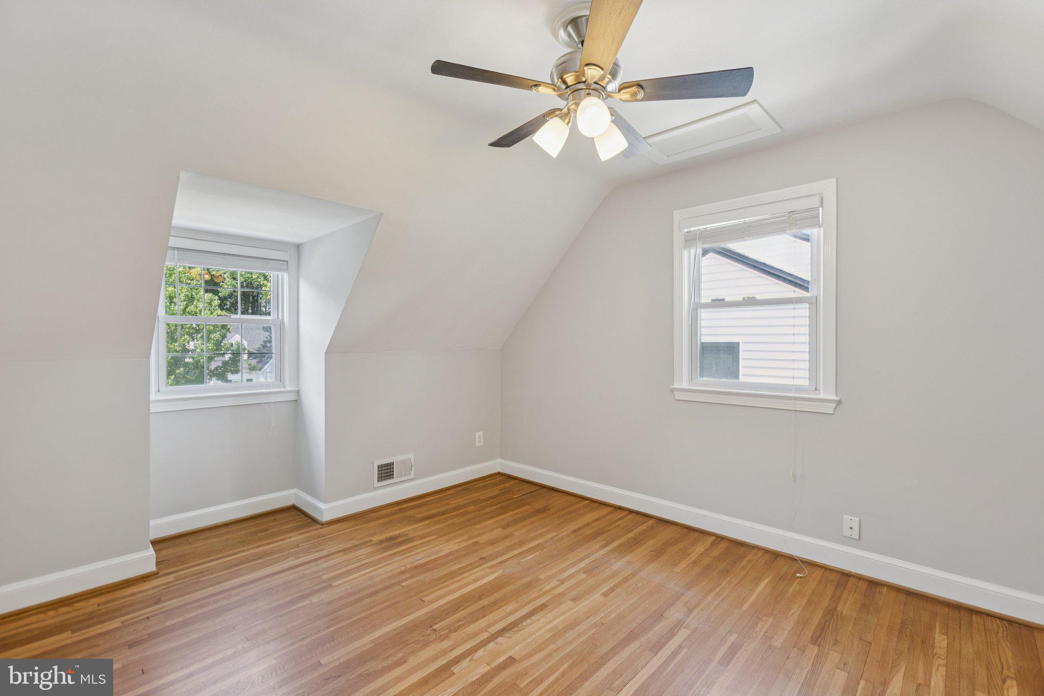 1718 Dublin Drive Silver Spring, MD 20902 - Photo 15 of 25 a view of empty room with wooden floor and fan