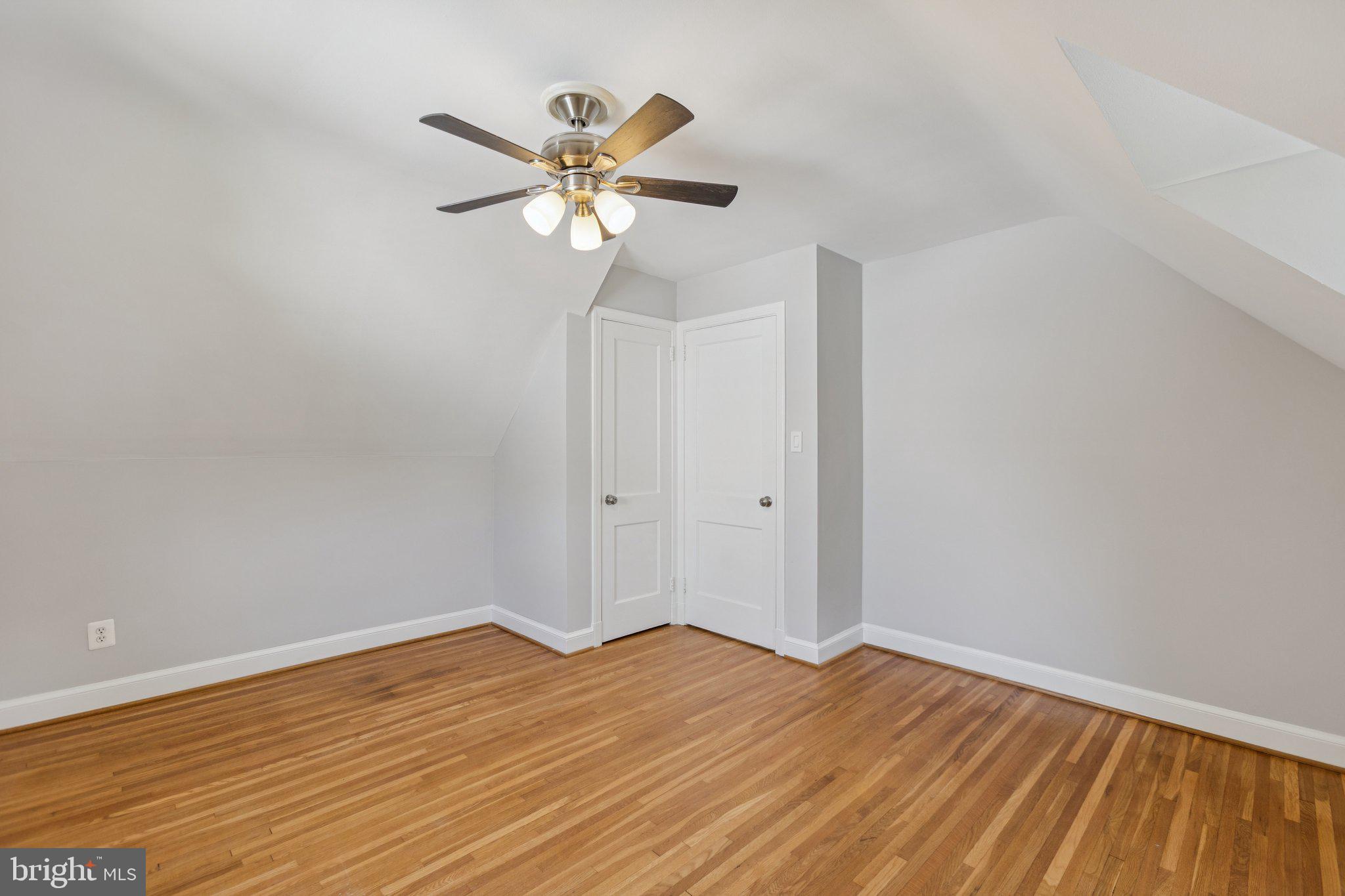 1718 Dublin Drive Silver Spring, MD 20902 - Photo 16 of 25 a view of a room with wooden floor and a ceiling fan