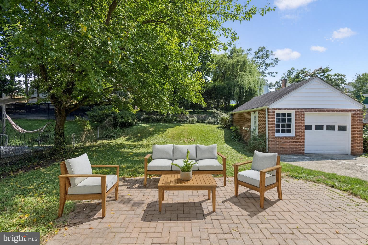 1718 Dublin Drive Silver Spring, MD 20902 - Photo 22 of 25 a view of a house with backyard sitting area and garden