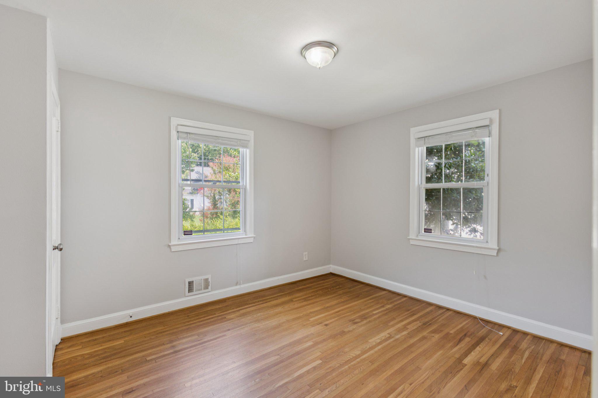 1718 Dublin Drive Silver Spring, MD 20902 - Photo 10 of 25 a view of an empty room with wooden floor and a window