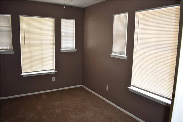 a view of room with window and ceiling fan