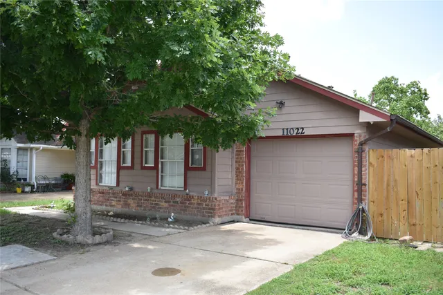 a kitchen with kitchen island granite countertop a sink cabinets and stainless steel appliances