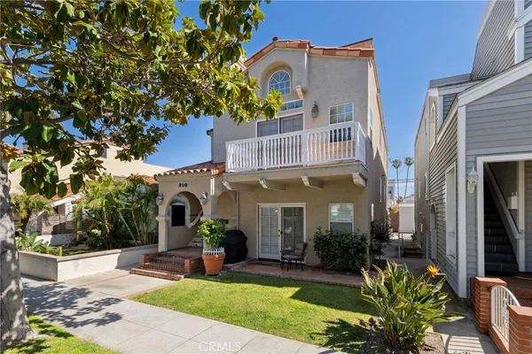 a view of a building with a yard and sitting area