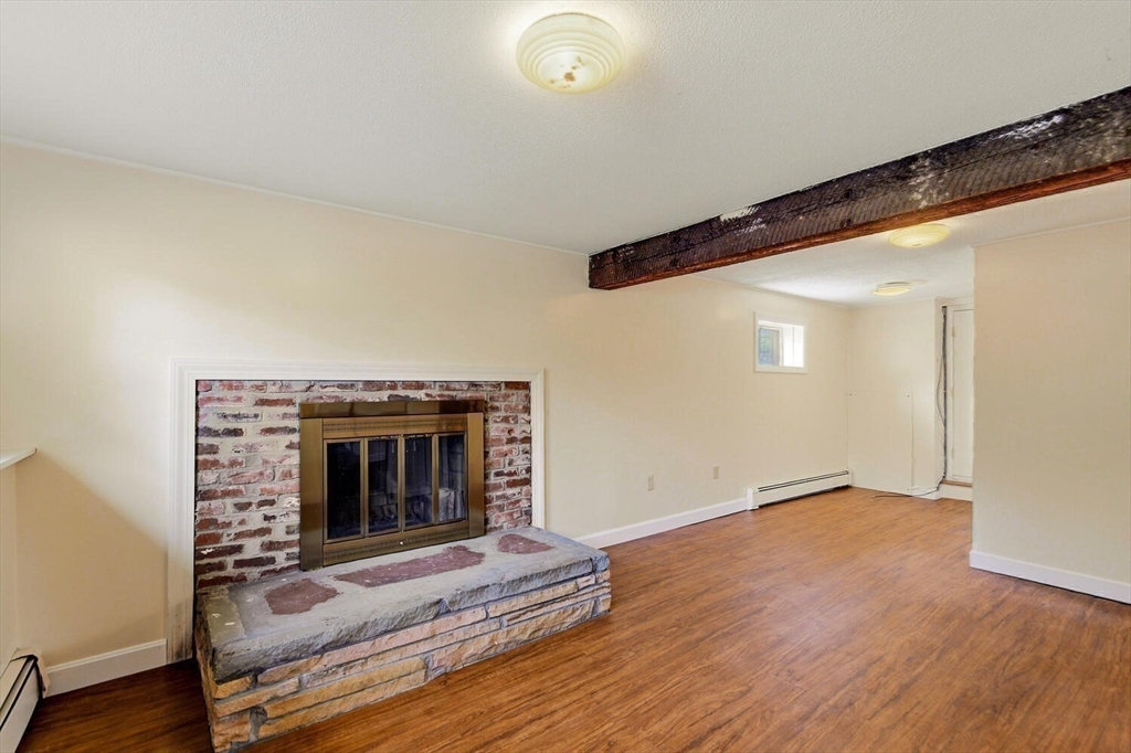 46 Plum Street Hamilton, MA 01982 - Photo 15 of 23 a view of an empty room with wooden floor and a window