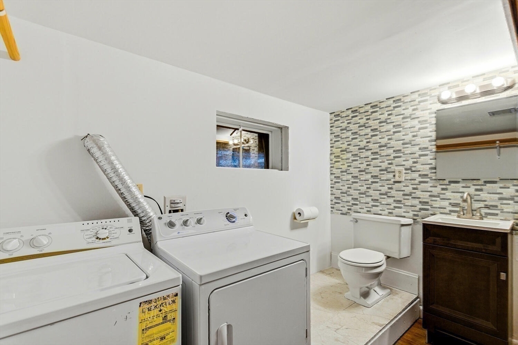 46 Plum Street Hamilton, MA 01982 - Photo 17 of 23 a bathroom with a sink a toilet and a mirror