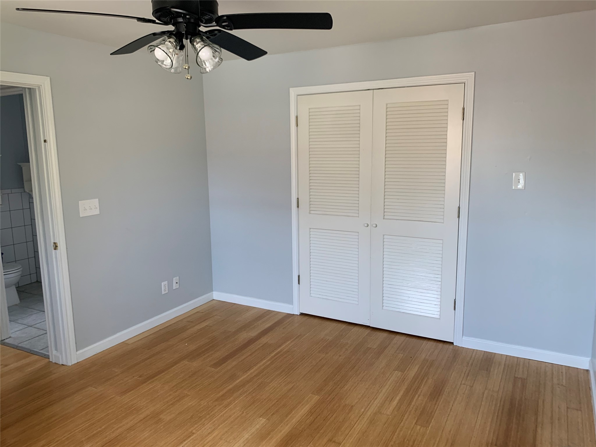 213 1st Street, Unit B Galveston, TX 77550 - Photo 13 of 16 an empty room with wooden floor closet and fan