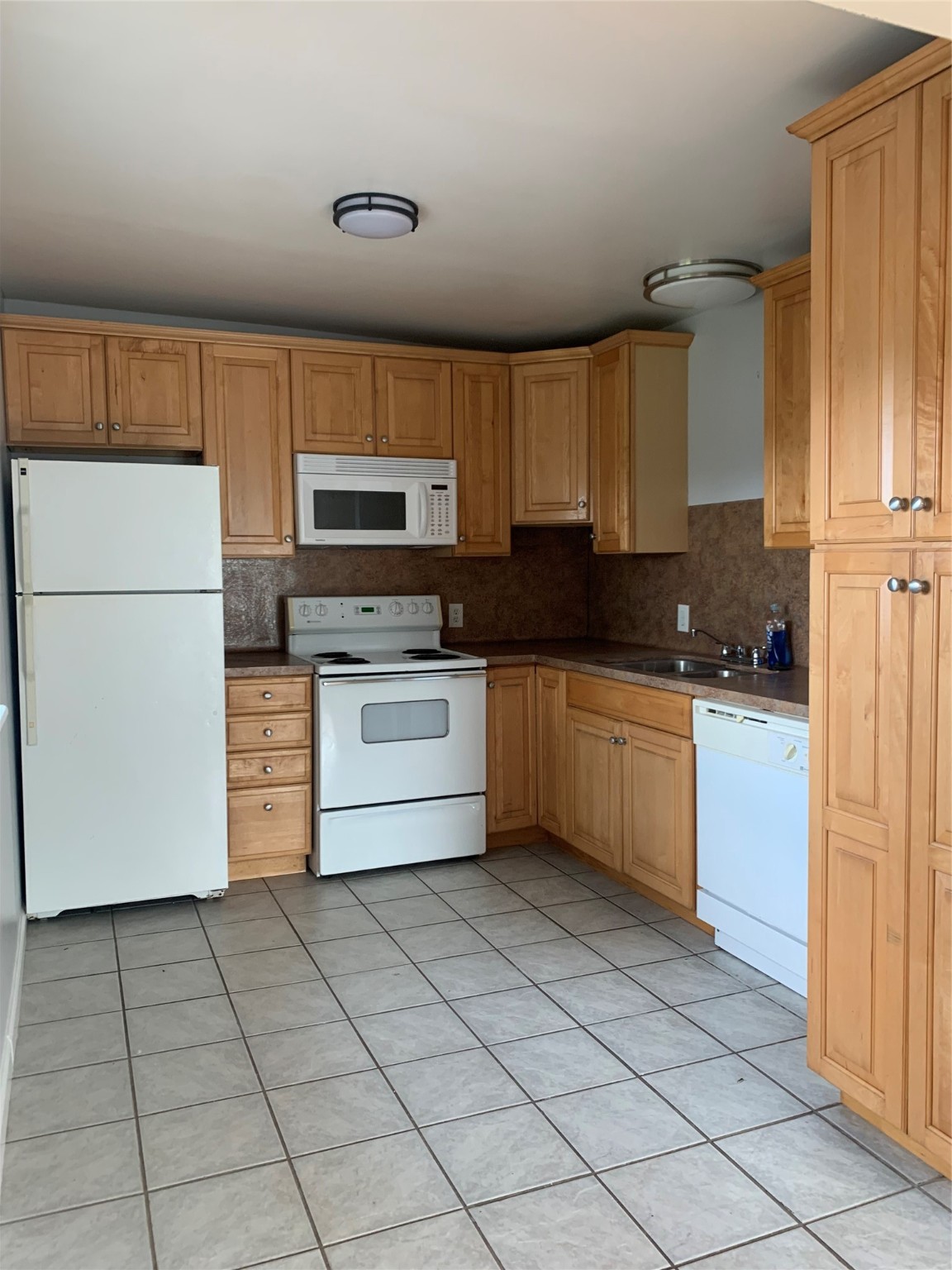 213 1st Street, Unit B Galveston, TX 77550 - Photo 4 of 16 a kitchen with a stove a sink and a refrigerator
