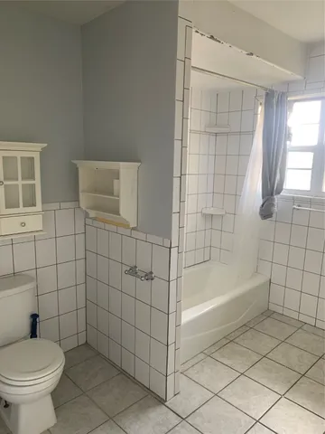 a bathroom with a bathtub and toilet