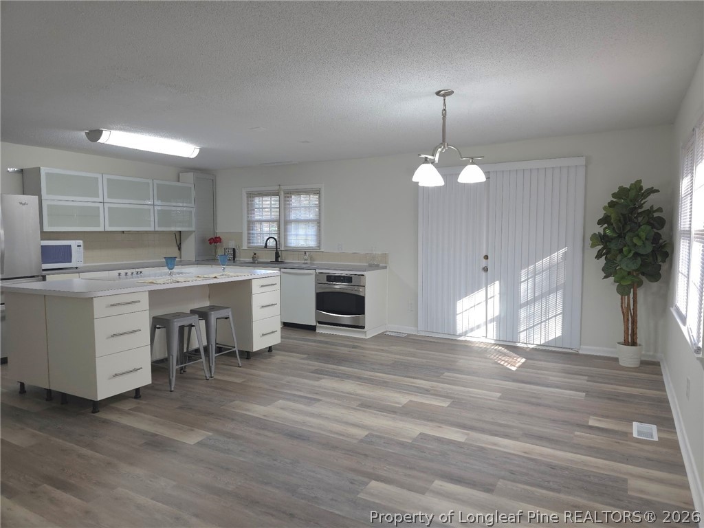 5945 Muscat Road Hope Mills, NC 28348 - Photo 13 of 36 a open kitchen that has a lot of white cabinets